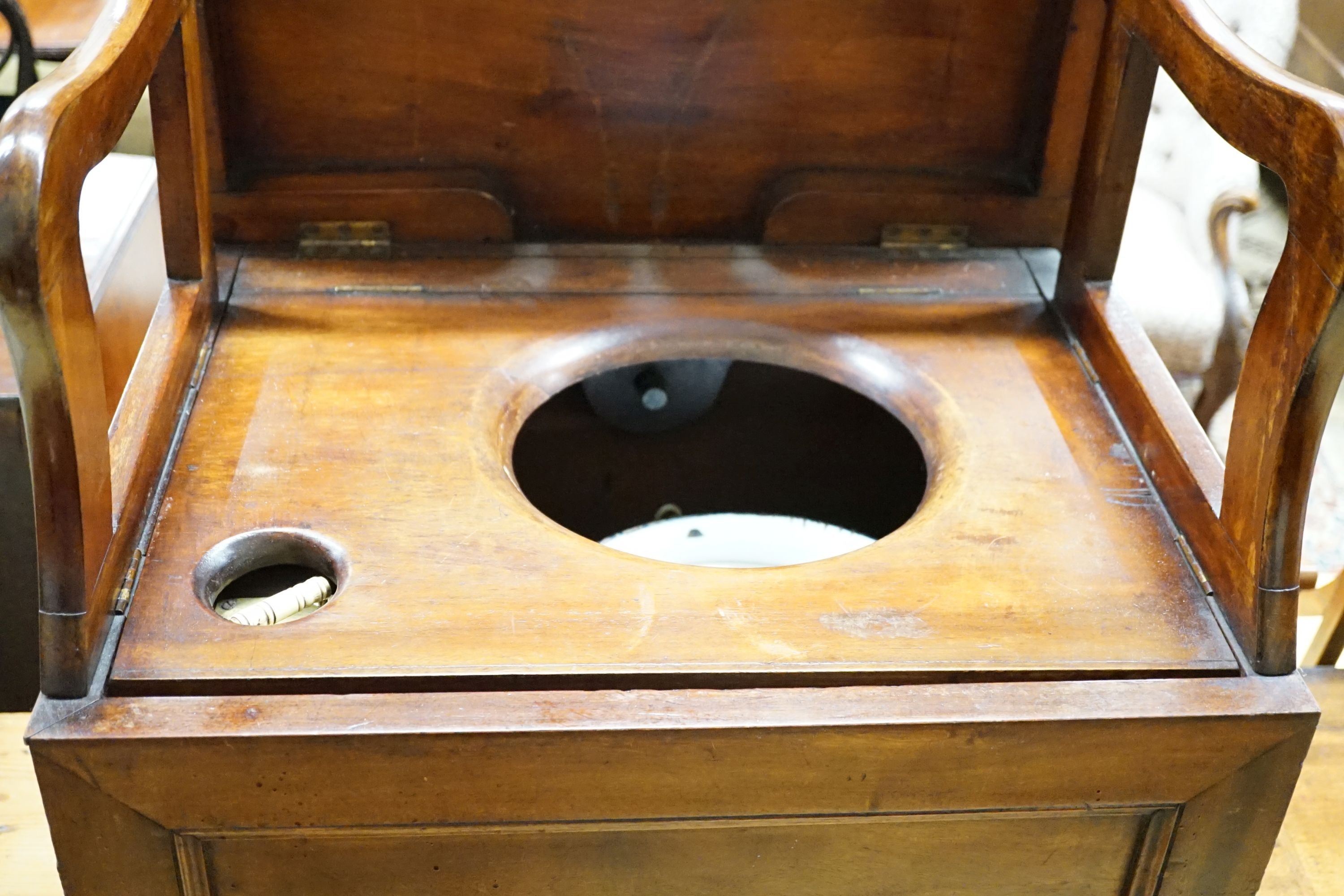 An early 19th century mahogany box commode with folding top and bone handled brass pump, width 57cm